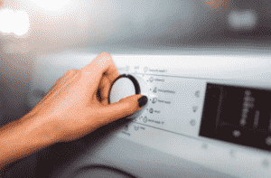 person turning on dryer machine